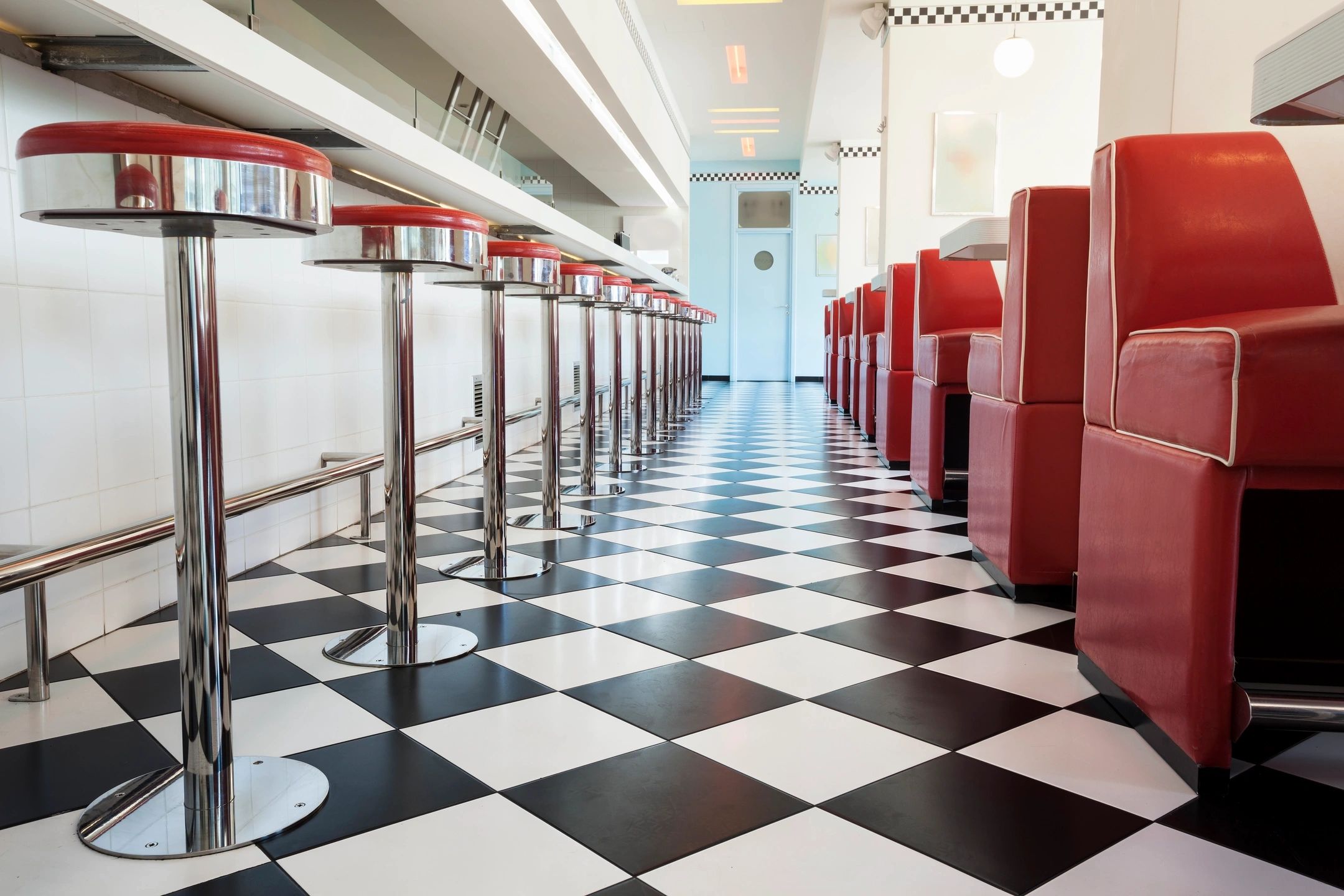 Spotlessly clean restaurant with shiny tile floors and well-maintained seating, demonstrating effective floor and upholstery cleaning services.