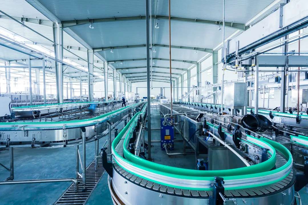 Industrial cleaning services at a food processing plant, showcasing sanitized production lines and clean equipment, ensuring compliance with health and safety regulations.