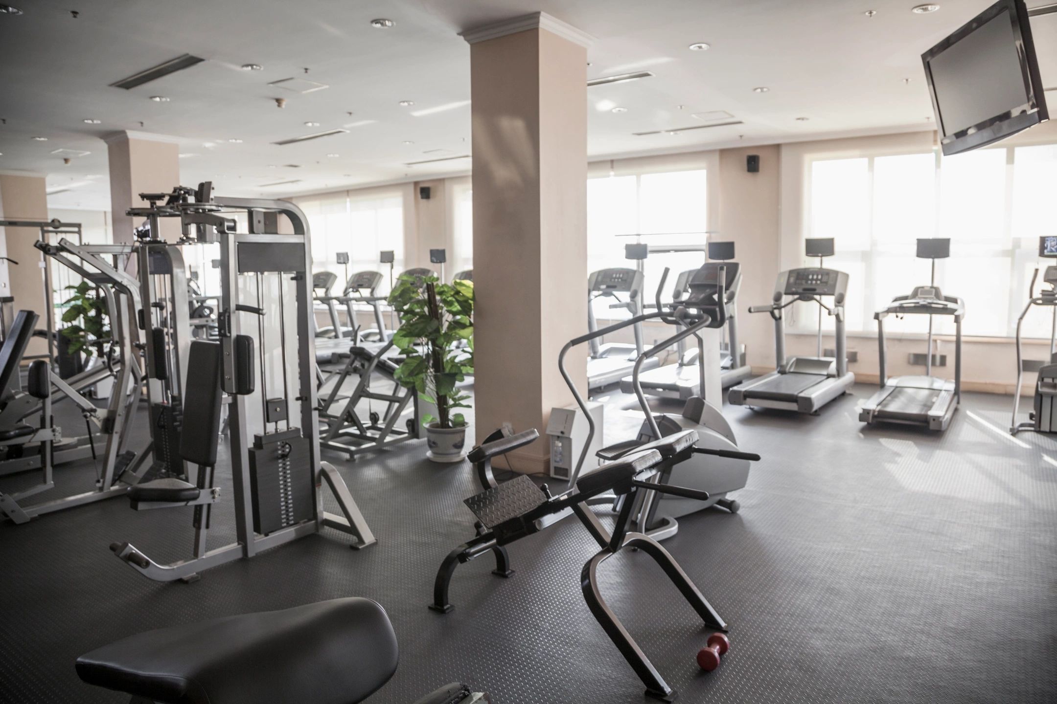 A clean gym with spotless floors and well-maintained equipment, demonstrating the effectiveness of gym cleaning services.