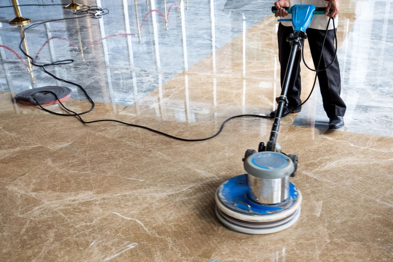 Warehouse cleaning services using a floor polishing machine for shiny surfaces