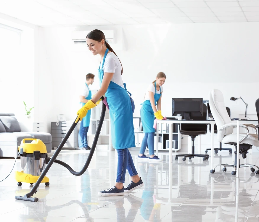 Professional cleaner organizing an office workspace as part of office cleaning services in Phoenix.