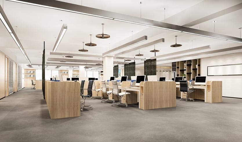 Clean, modern open-plan office with wooden desks and ergonomic chairs.
