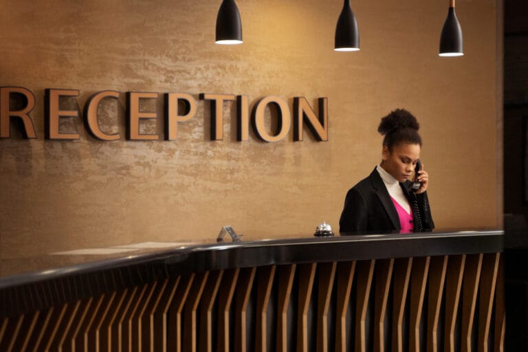 Hotel cleaning Miami FL — pristine hotel reception area with polished front desk and modern lighting