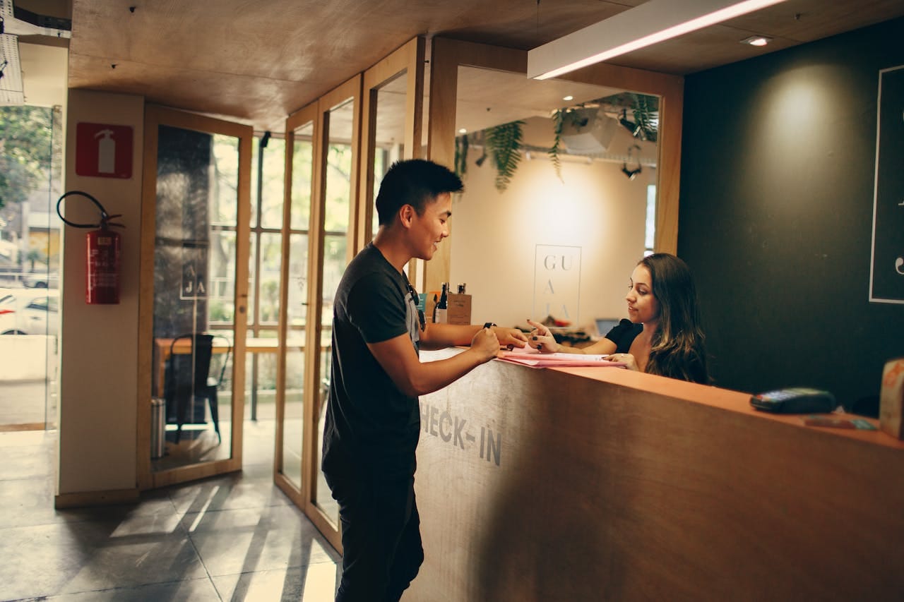Hotel guest checking in at a clean reception desk in a Portland boutique hotel