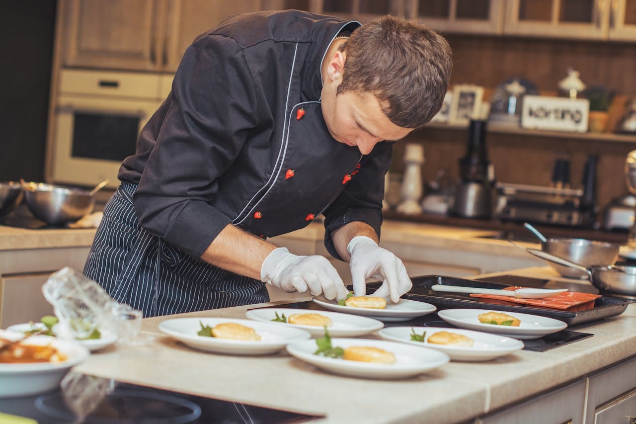 hef plating dishes in a clean restaurant kitchen in Portland