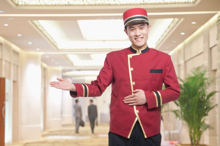 Hotel bellhop in uniform welcoming guests in a clean Seattle hotel lobby